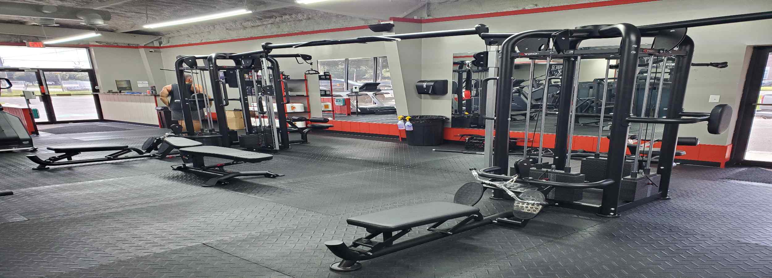 Gym interior with TKO exercise machines and equipment.